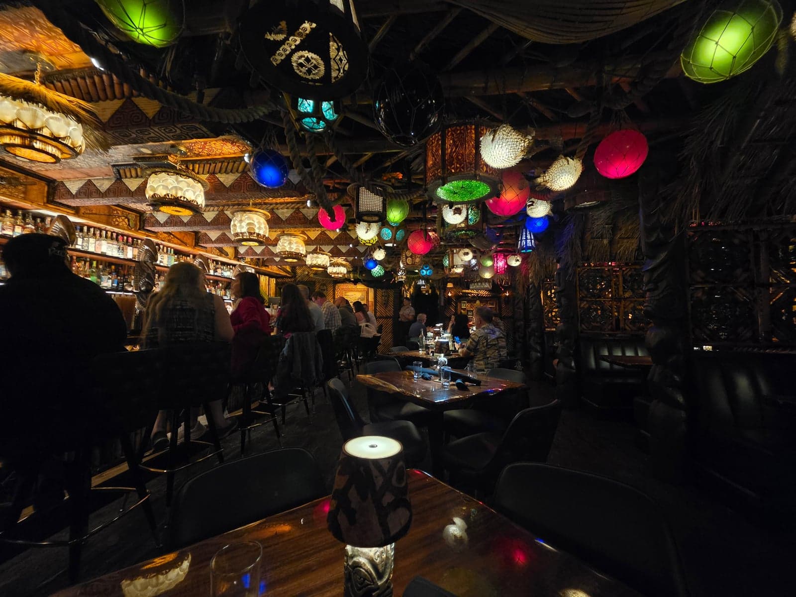 Colored glass lanterns glowing over the dark wood bar and booths at House of Bamboo in Old Town Camarillo