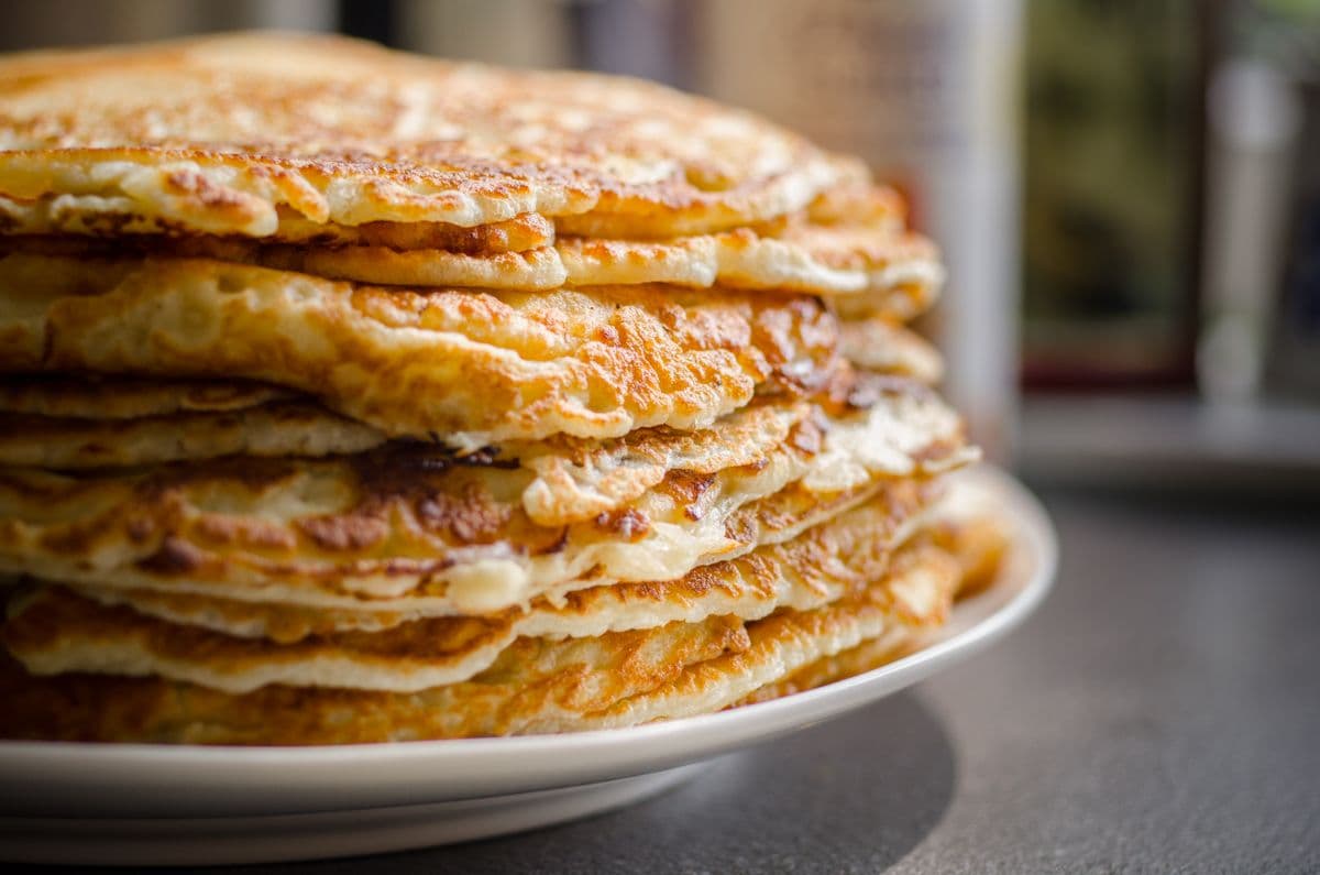 A tall stack of pancakes at a community breakfast
