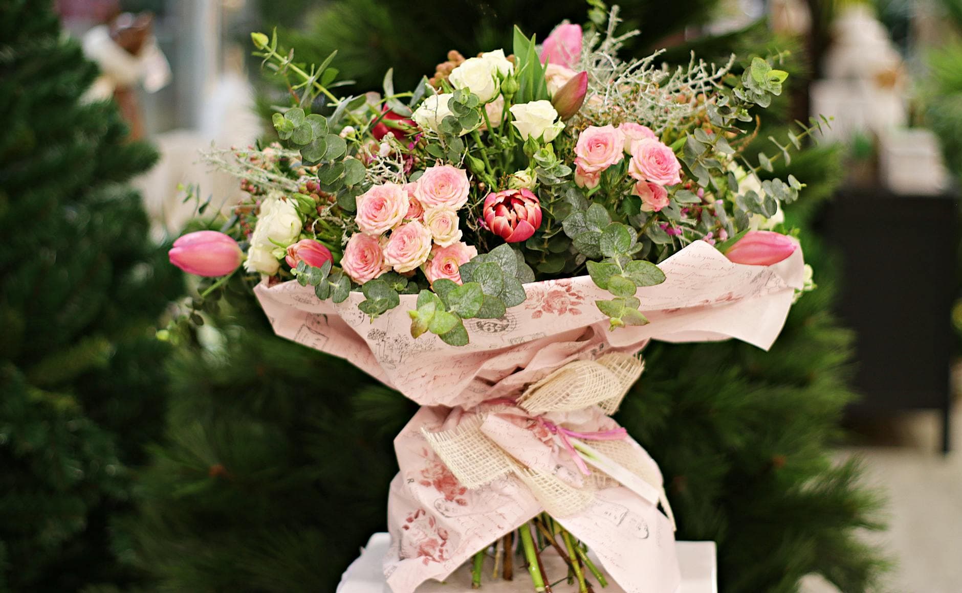 A pink and white rose bouquet wrapped in floral paper, a classic Mother's Day gift