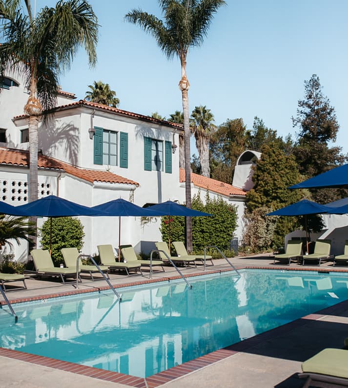 Ojai Valley Inn pool surrounded by Spanish-Colonial architecture and palms