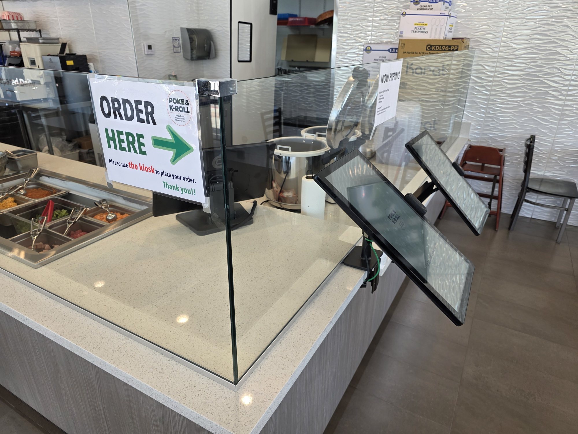 An Order Here sign and self-order kiosks on the counter at Poke & K-Roll in Camarillo